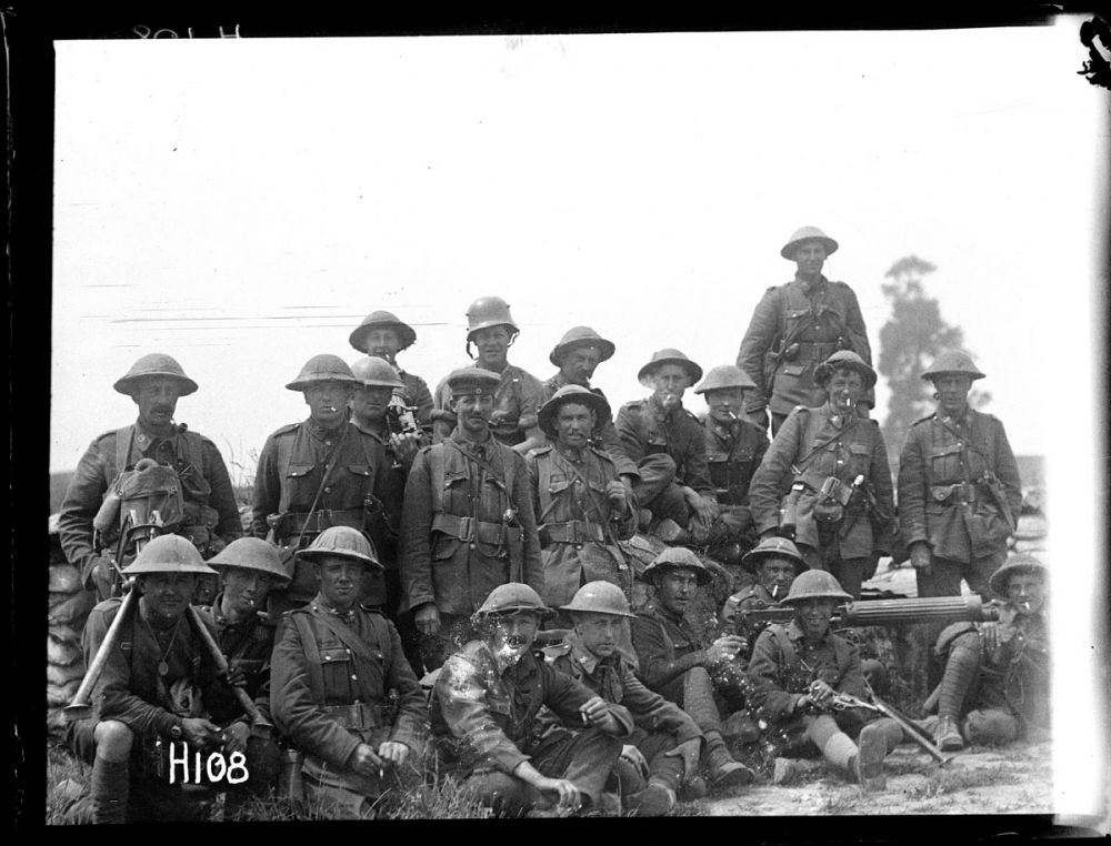 A New Zealand machine gun company, some wearing German trophies, take a well-deserved break after the Battle of Messines. June 1917.